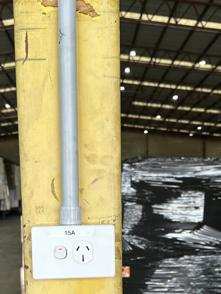 New 15 amp power outlet on a warehouse column in Acacia Ridge, with the cable run in conduit