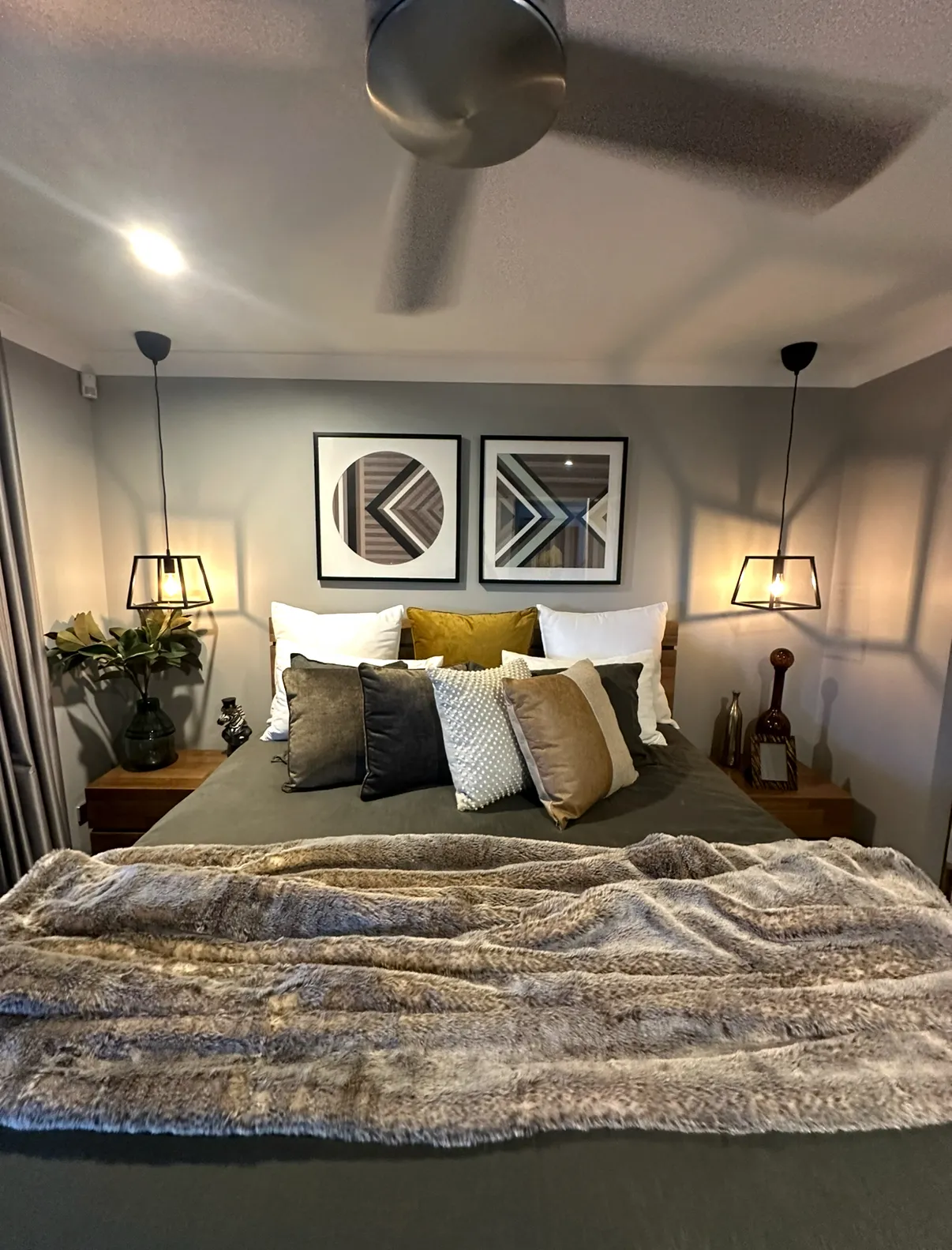 Bedroom with downlights, a ceiling fan and bedside wall lights installed by M-Tech
