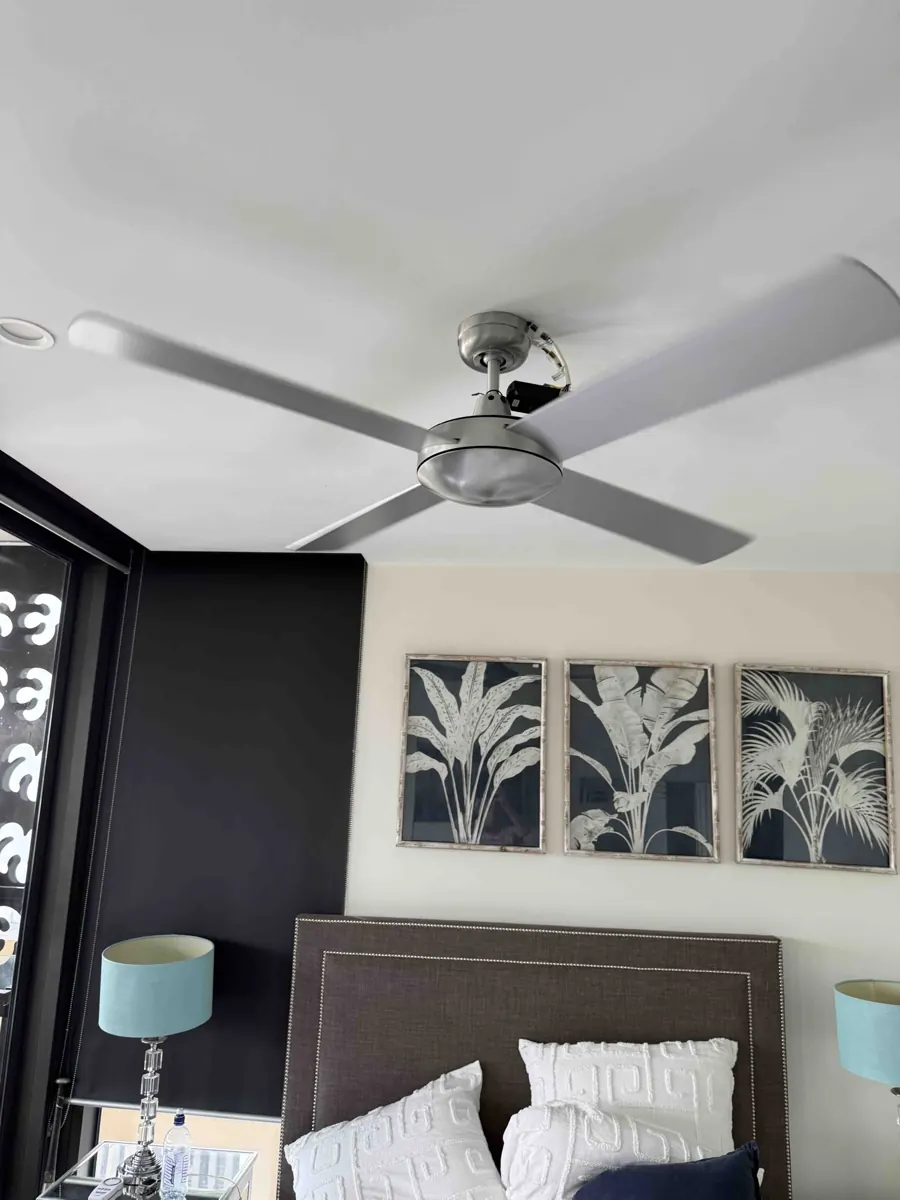 DC ceiling fan with light kit installed in a West End bedroom