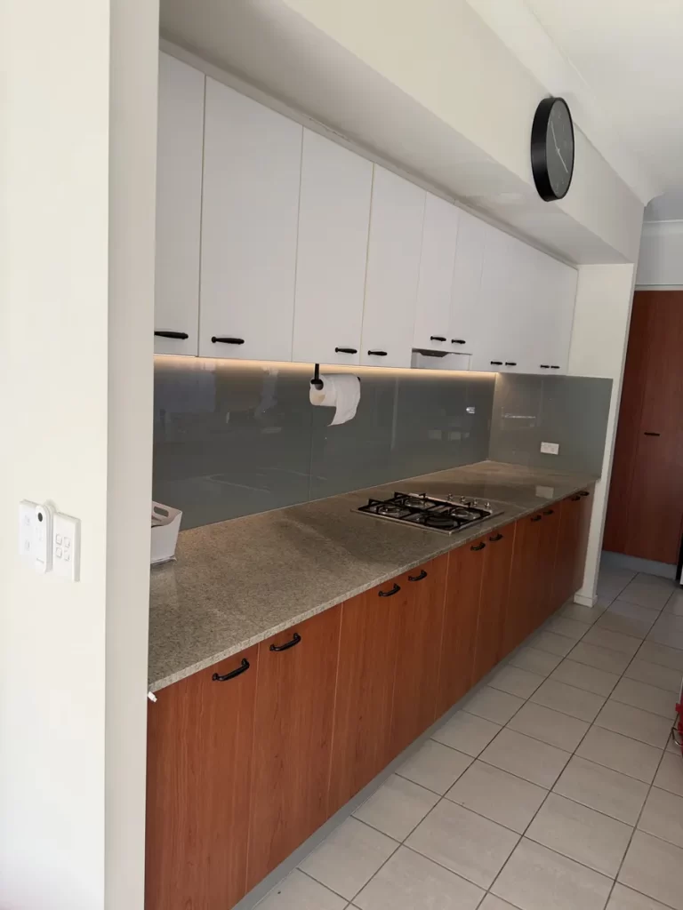 Warm white COB LED strip lighting in a channel under kitchen cabinets in Wakerley