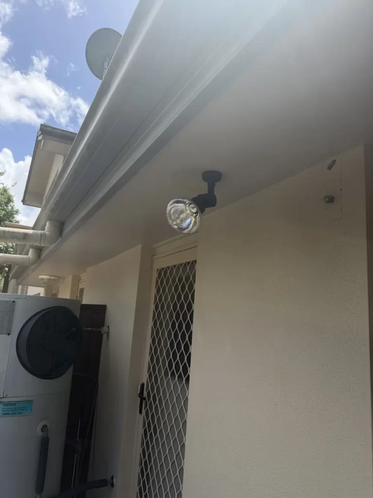Outdoor lighting installation in Richlands: a customer-supplied spotlight fitted under the eave