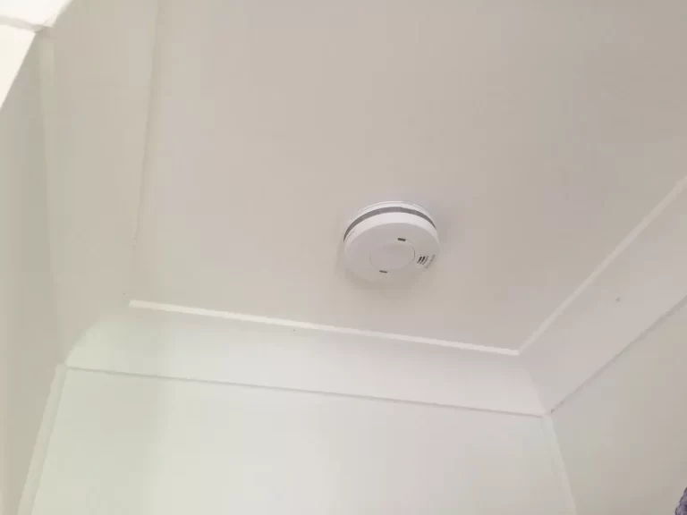Smoke alarm installed on a ceiling near the cornice by M-Tech in Brisbane