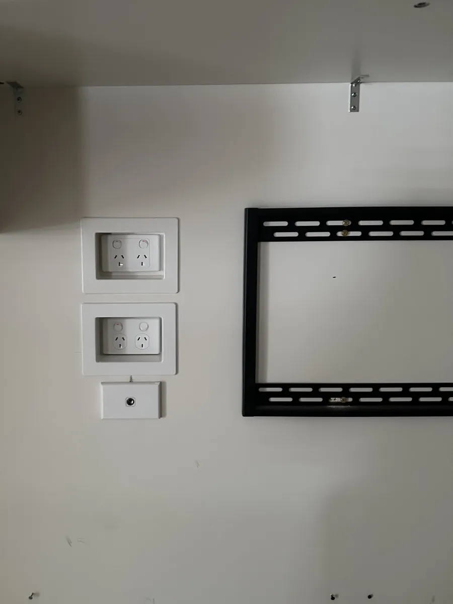 Two new double power points and an antenna point behind a wall-mounted TV in Springfield Lakes, fitted so the power boards could go