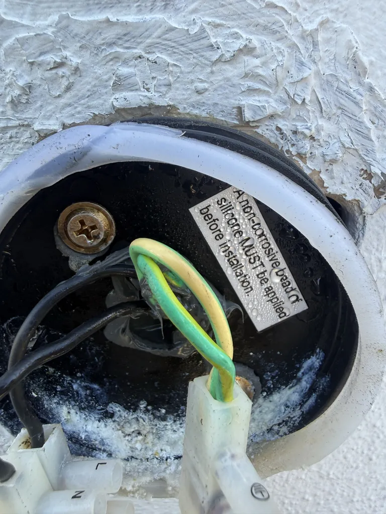 Water damage inside an outdoor sensor light that kept tripping the front lights at a Bulimba home